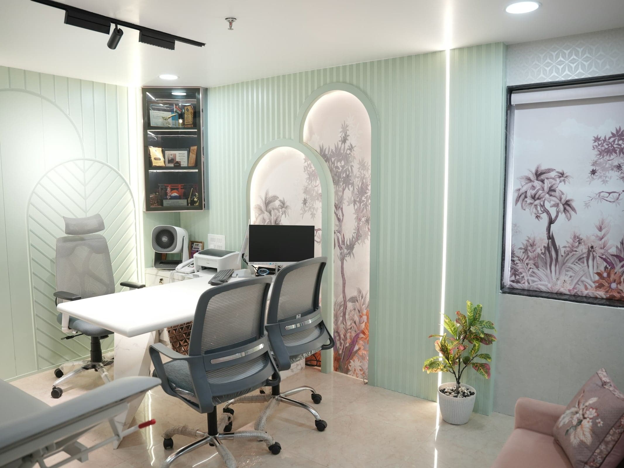 A consultation room with a desk and chairs